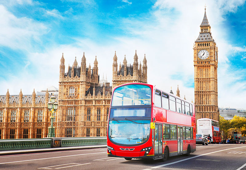 A London bus travelling past the Houses of Parliament in London