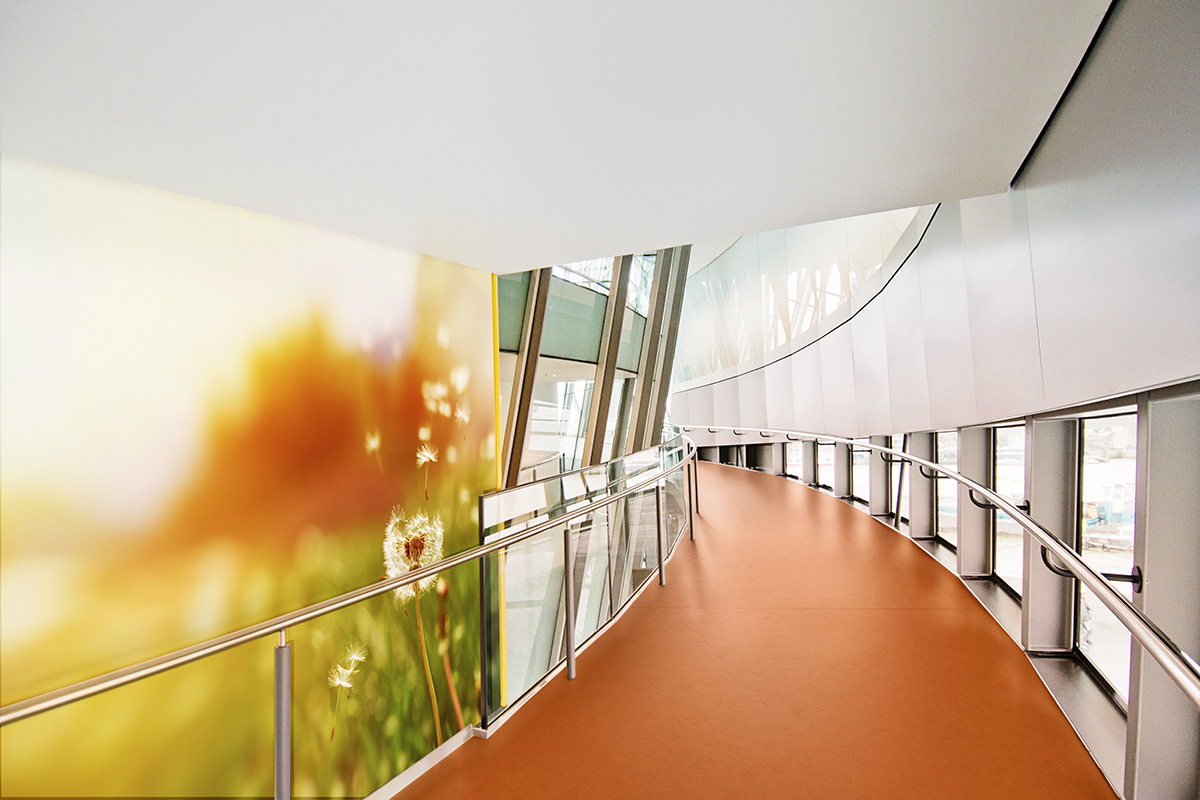 Image of Altro Operetta in an orange shade in a curving corridor