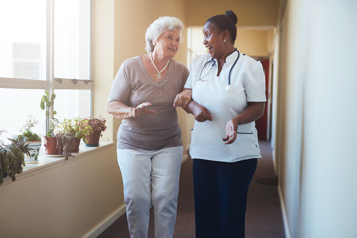 Care homes-Healthcare worker chats to resident