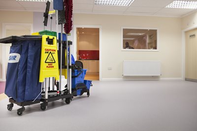 Link to Top Tips for Safety Floor Cleaning. An image of an industrial cleaning cart in a room with Altro Safety flooring.