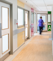 Safety floor header. A nurse walking along a hospital corridor.