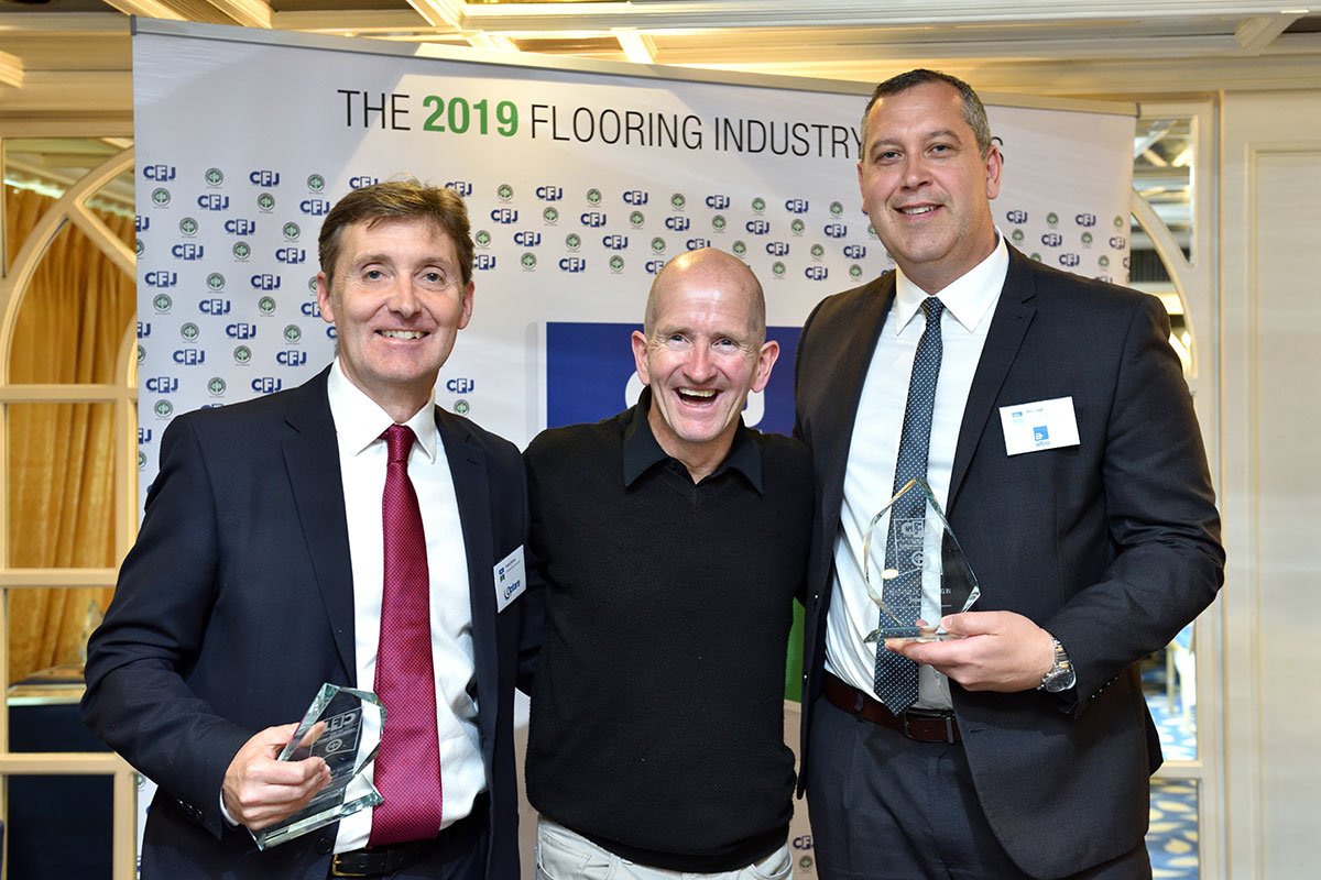 Representatives from Optare and Altro accepting the award from Eddie the Eagle