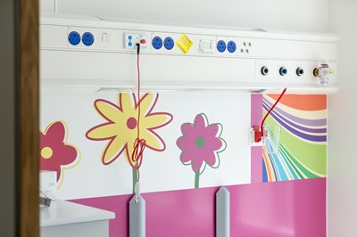 Walls header. Altro Whiterock Digiclad printed with flowers on a hospital ward.